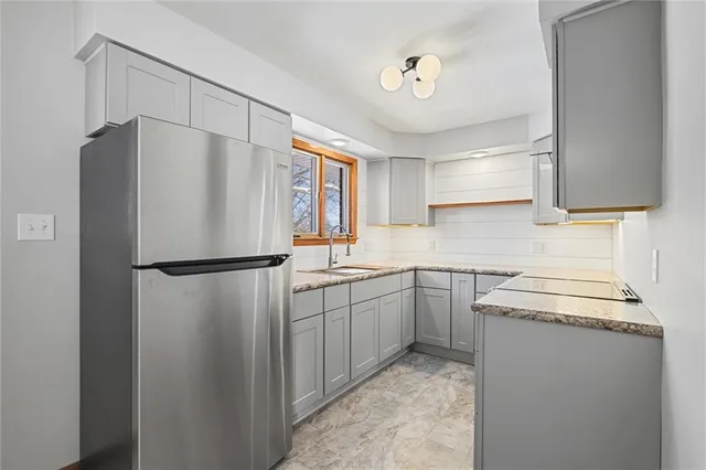 a kitchen with a refrigerator sink stove and cabinets