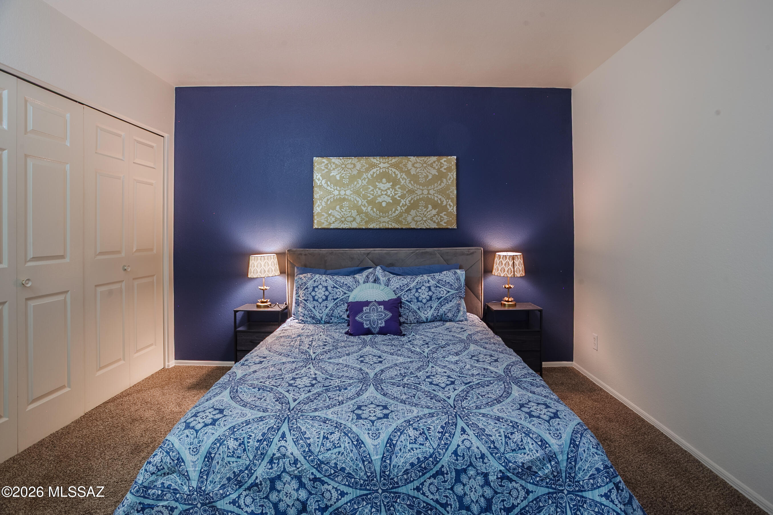 1200 East River Road, Unit B27 Tucson, AZ 85718 - Photo 22 of 40 a bed sitting in a bedroom next to a bathroom