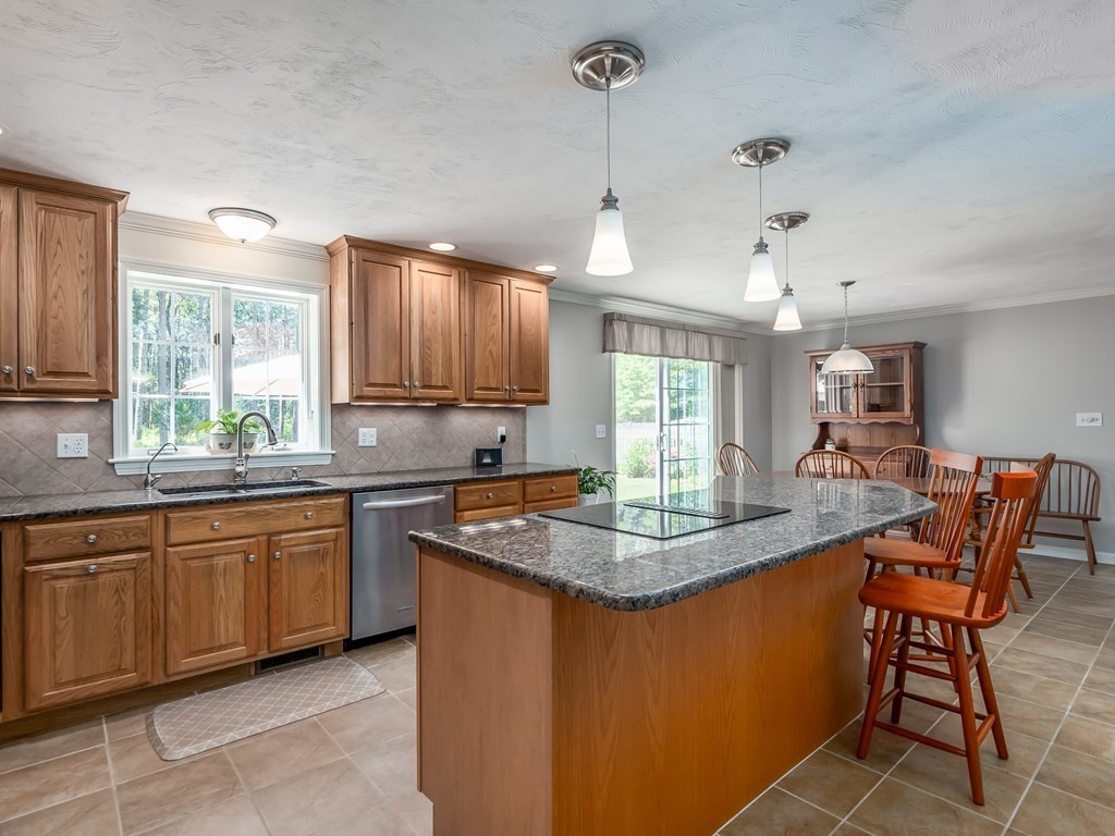 76 Williams Way Rochester, MA 02770 - Photo 11 of 42 a kitchen with stainless steel appliances granite countertop stove a sink a dining table and chairs
