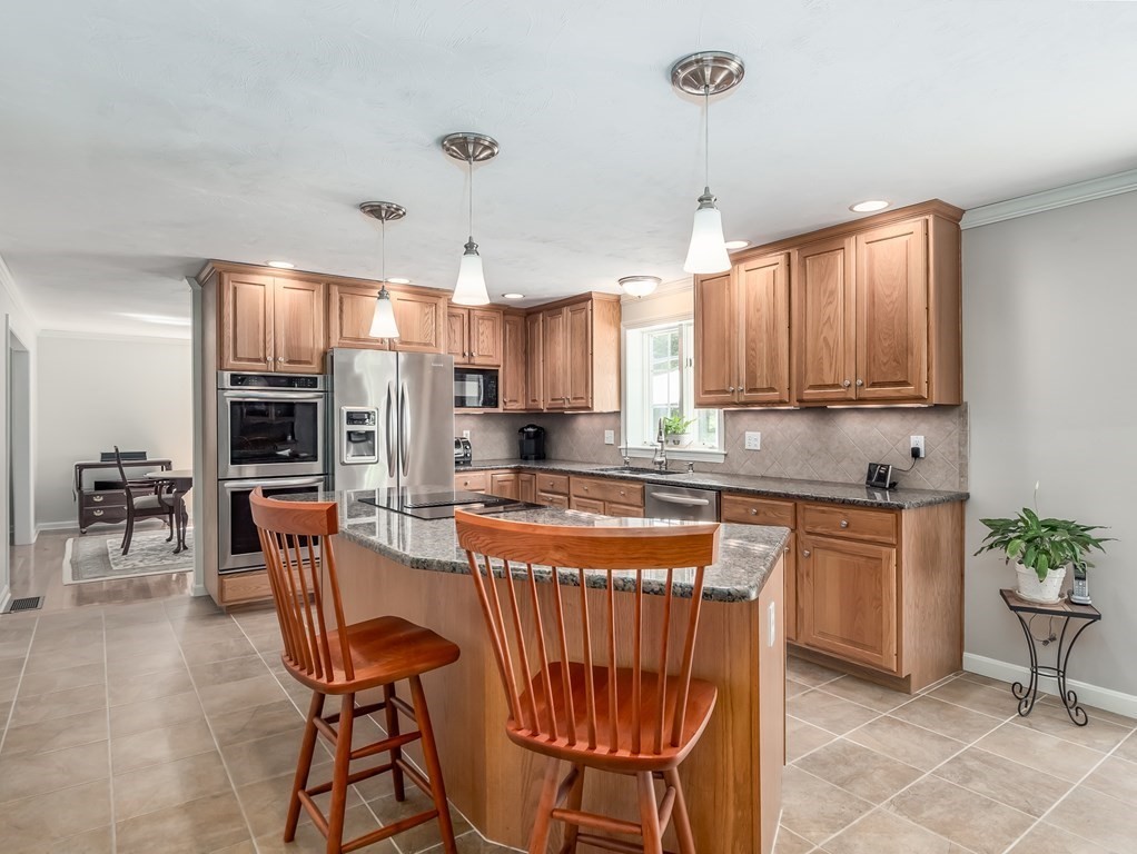 76 Williams Way Rochester, MA 02770 - Photo 12 of 42 a kitchen with stainless steel appliances granite countertop a stove top oven a refrigerator a sink and chairs