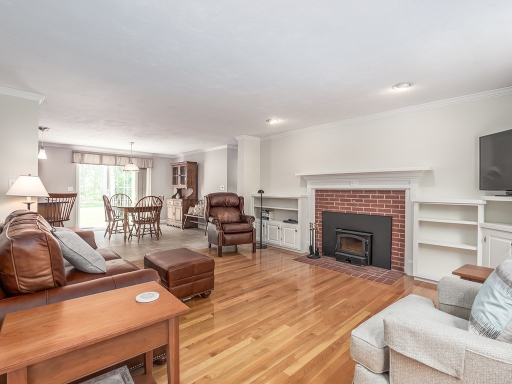 76 Williams Way Rochester, MA 02770 - Photo 14 of 42 a living room with furniture a fireplace and a television