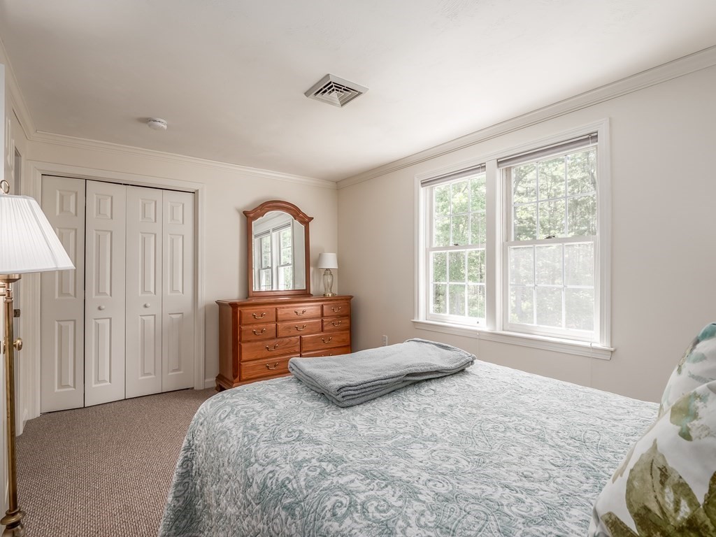 76 Williams Way Rochester, MA 02770 - Photo 25 of 42 a bedroom with a bed and a dresser next to a window