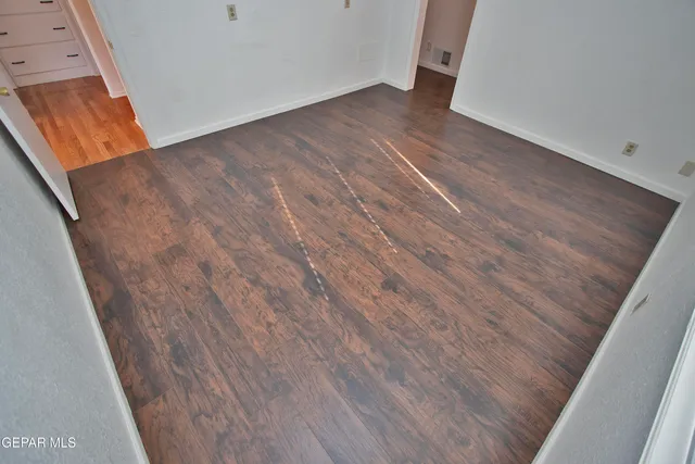 a kitchen with granite countertop a sink cabinets stainless steel appliances and a window