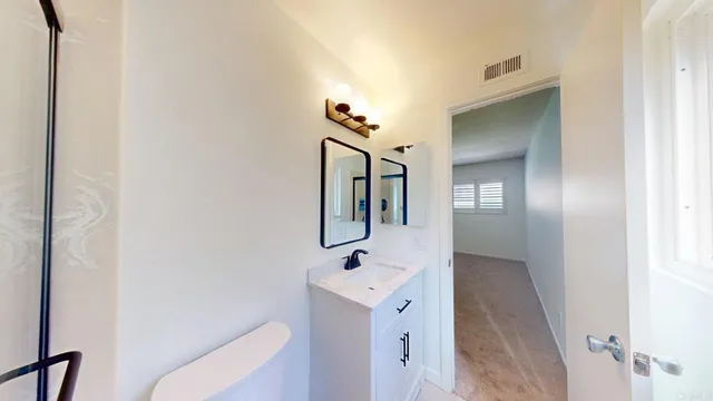 a bathroom with a shower and a sink