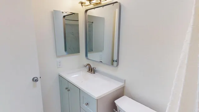 a view of bathroom with a shower and a sink