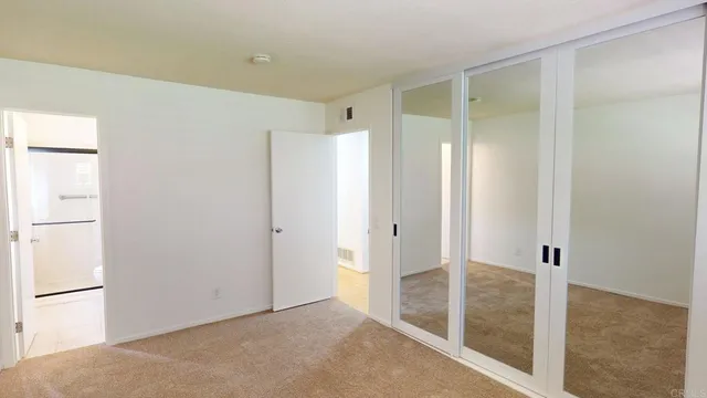 an empty room with furniture and a window
