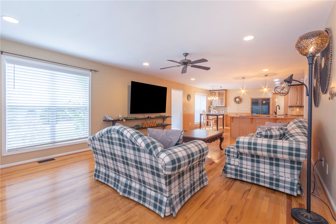 125 Inlet Pointe Drive Anderson, SC 29625 - Photo 10 of 39 Hardwood floors and generous natural light create an inviting atmosphere in this open-concept living space.