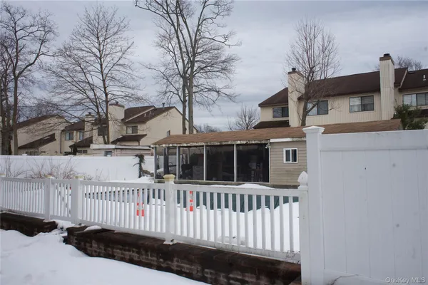 a view of a house with a wooden fence