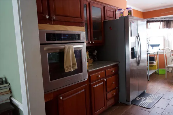 a kitchen with stainless steel appliances granite countertop a refrigerator and a stove