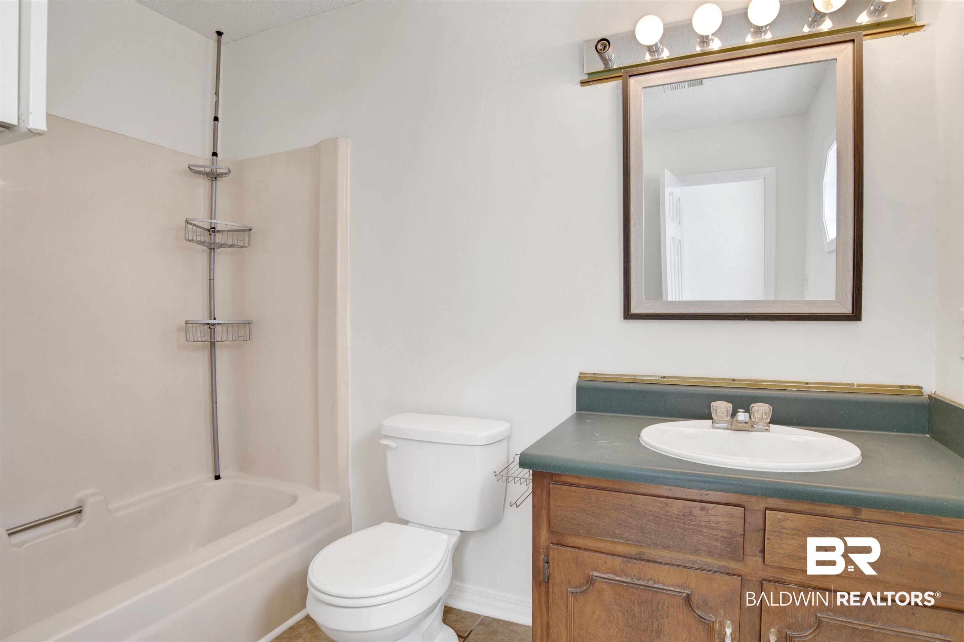 5480 Country Club Boulevard Theodore, AL 36582 - Photo 23 of 36 Full bathroom featuring tile patterned floors, bathtub / shower combination, toilet, and vanity