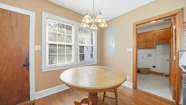 a view of a dining room with furniture wooden floor and chandelier