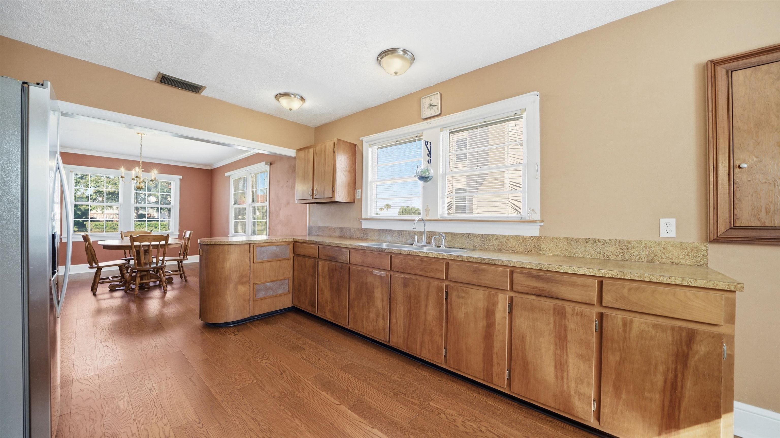 196 Inlet Drive St. Augustine, FL 32080 - Photo 18 of 52 a large white kitchen with cabinets a sink a window and chairs