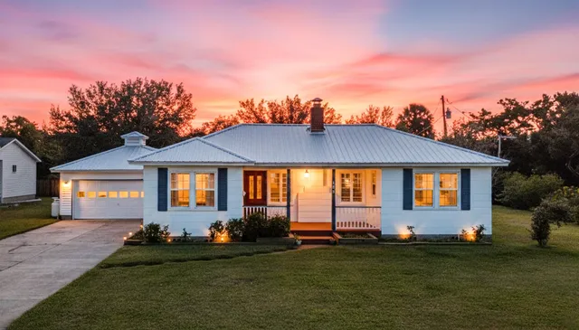 a front view of a house with a garden