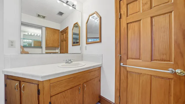 a bathroom with a tub sink and a window