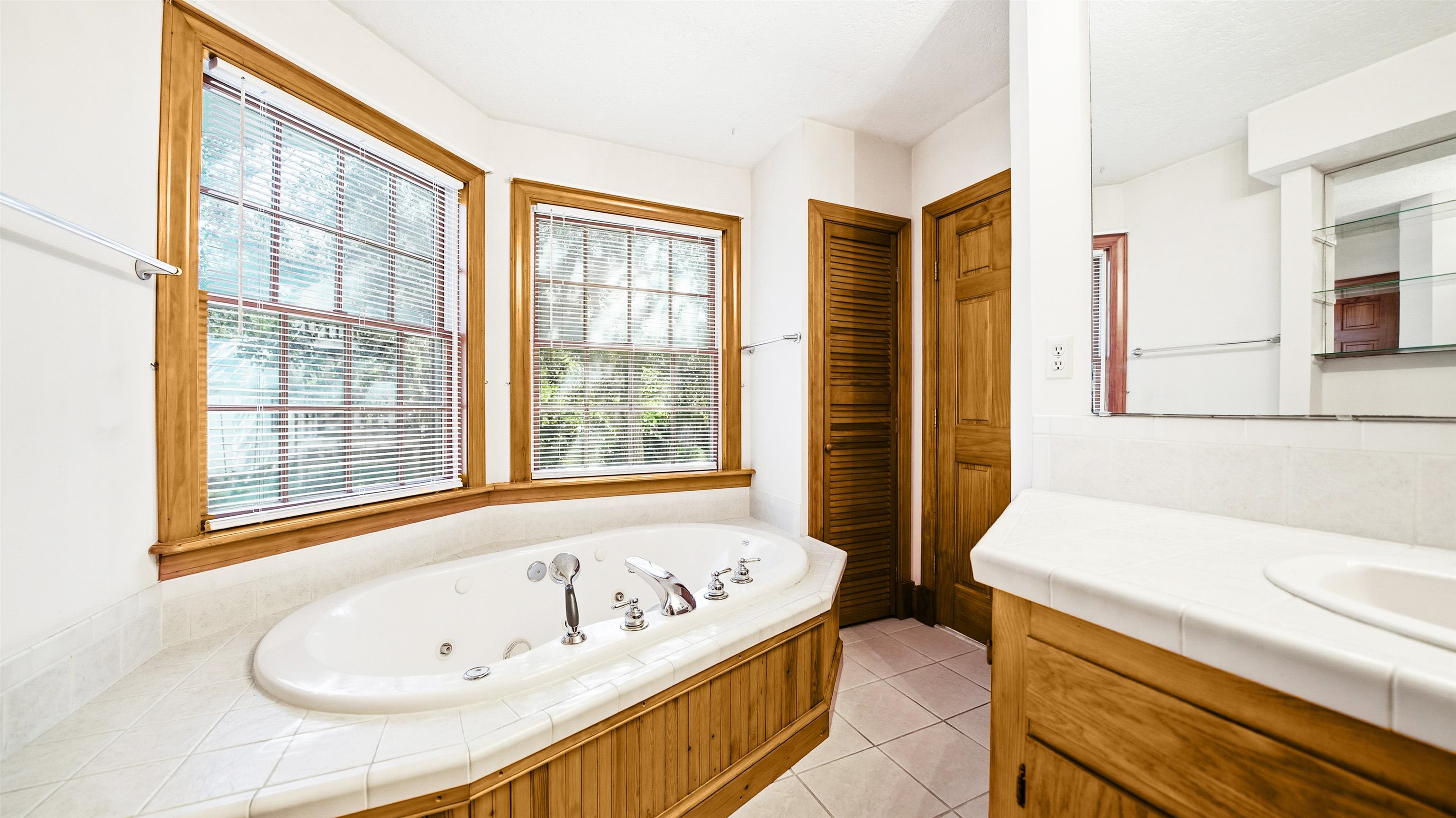196 Inlet Drive St. Augustine, FL 32080 - Photo 25 of 52 a bathroom with a tub sink and a window
