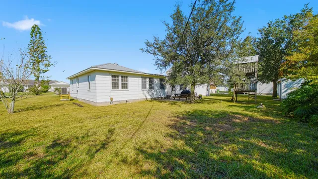 a swimming pool with outdoor seating and yard