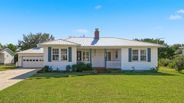 an aerial view of a houses with a lake view