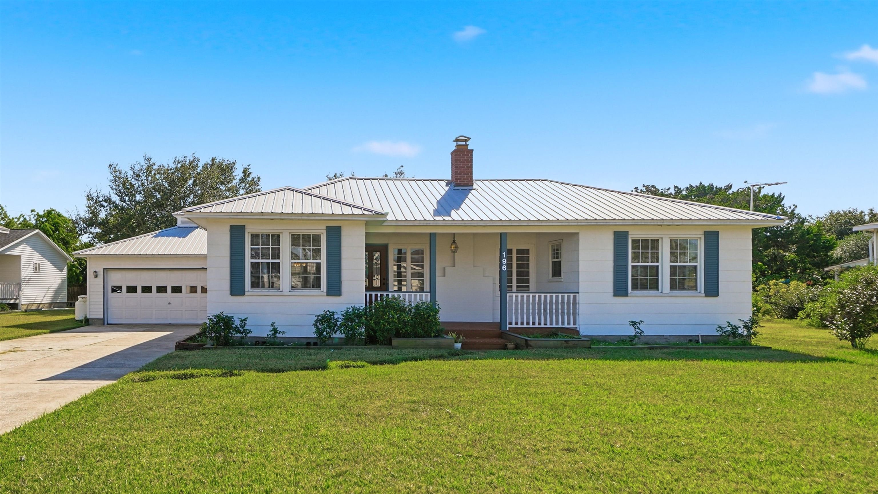 196 Inlet Drive St. Augustine, FL 32080 - Photo 43 of 52 a front view of a house with garden