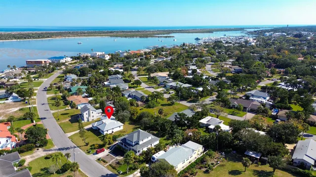 an aerial view of a houses with a swimming pool