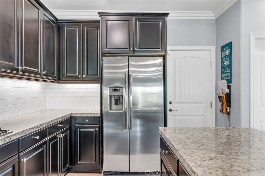 16568 Fleur Boulevard Riverside, CA 92503 - Photo 11 of 48 a kitchen with granite countertop a refrigerator and a sink