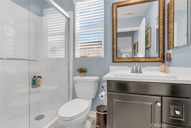 a bathroom with a sink toilet vanity and mirror
