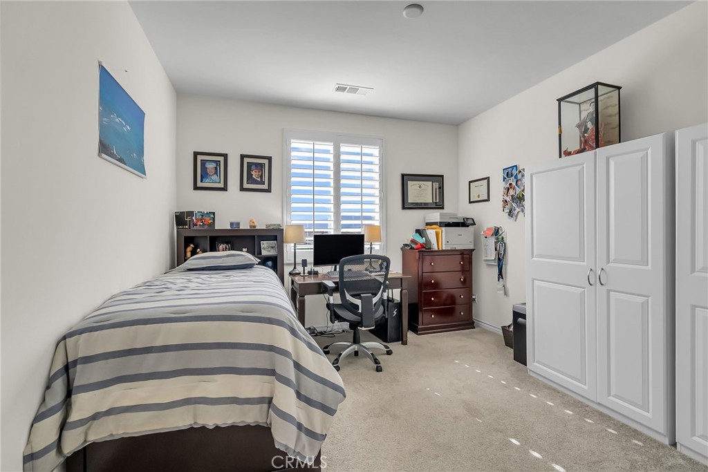 16568 Fleur Boulevard Riverside, CA 92503 - Photo 18 of 48 a bed room with a bed and a chair