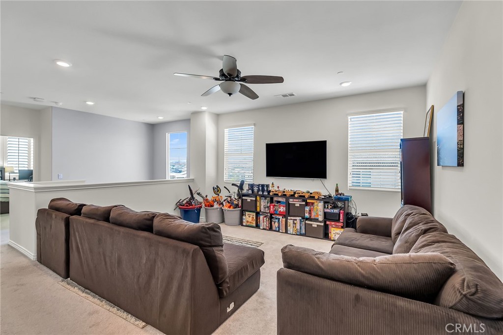 16568 Fleur Boulevard Riverside, CA 92503 - Photo 23 of 48 a living room with furniture and a flat screen tv