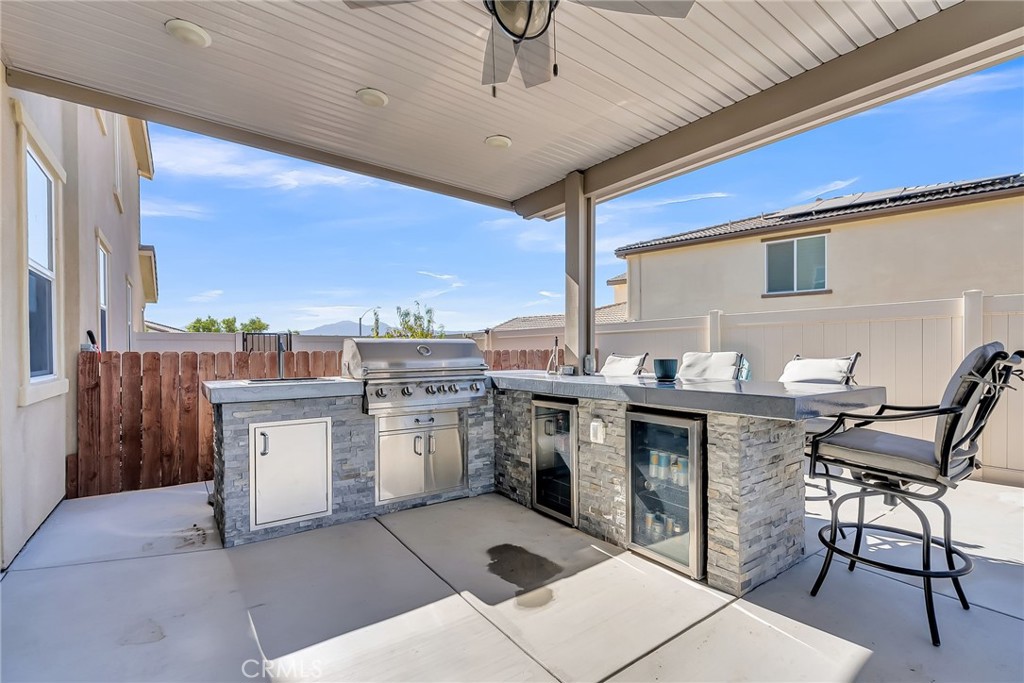16568 Fleur Boulevard Riverside, CA 92503 - Photo 32 of 48 a kitchen with a sink a stove cabinets and dining table
