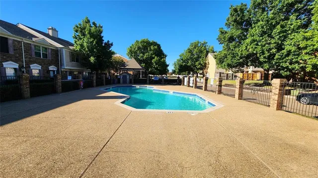 a swimming pool with outdoor seating and yard