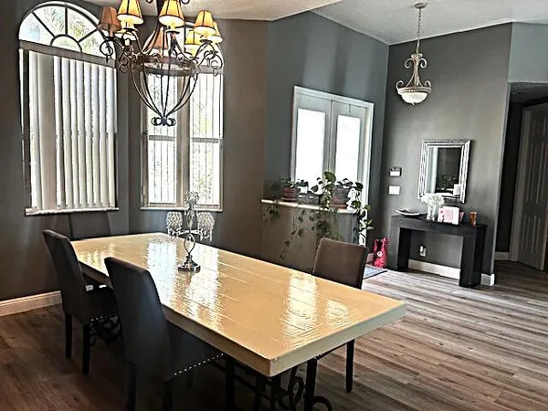 a view of a dining room with furniture and chandelier