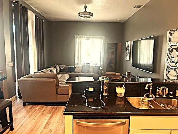 a living room with a bed furniture and a flat screen tv