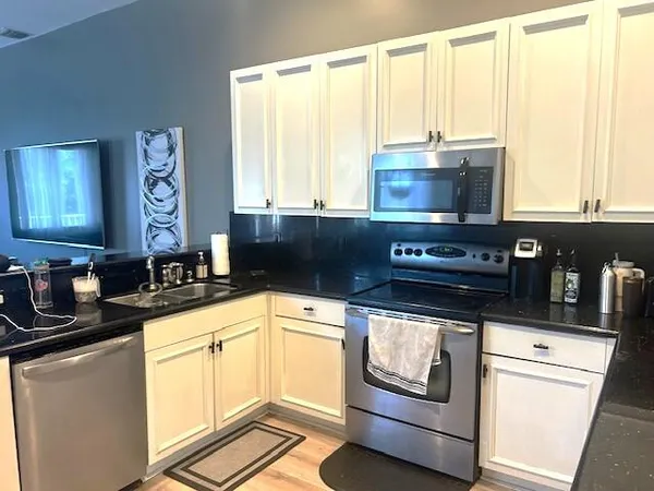 a kitchen with a table chairs and cabinets