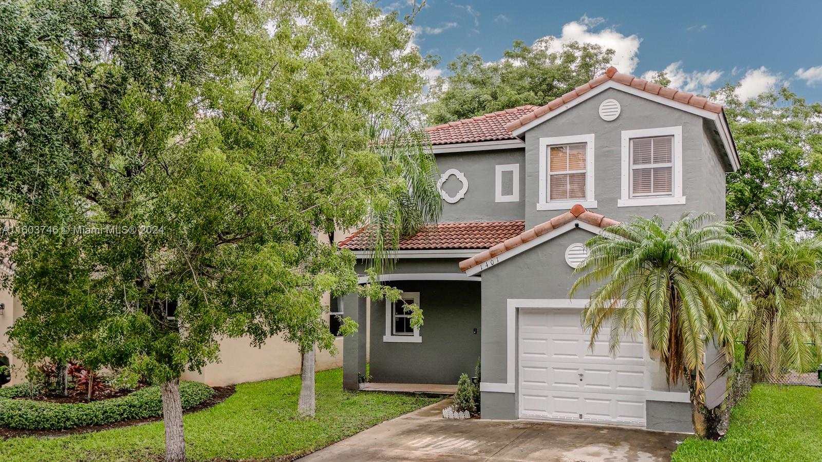 1401 Southeast 20th Road Homestead, FL 33035 - Photo 2 of 24 a front view of a house with a garden