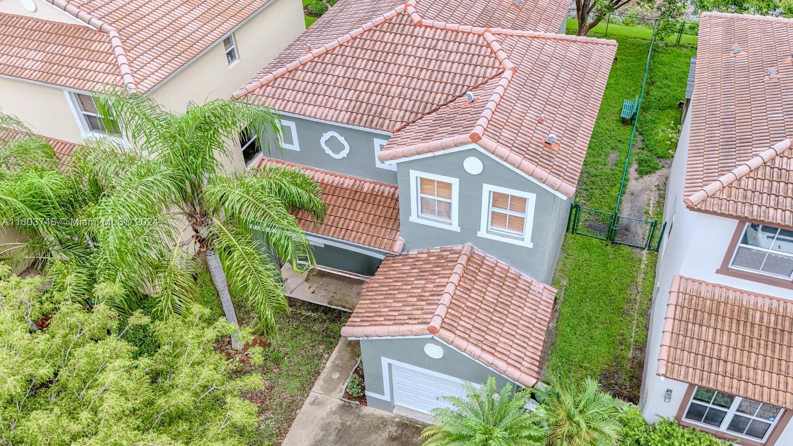1401 Southeast 20th Road Homestead, FL 33035 - Photo 3 of 24 a front view of a multi story residential apartment building with a yard