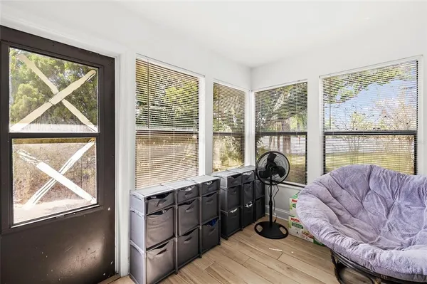 a living room with furniture and a floor to ceiling window