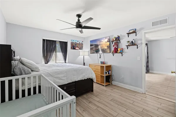 a bedroom with a bed and a chandelier