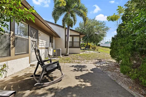 a view of a backyard with chair and tables