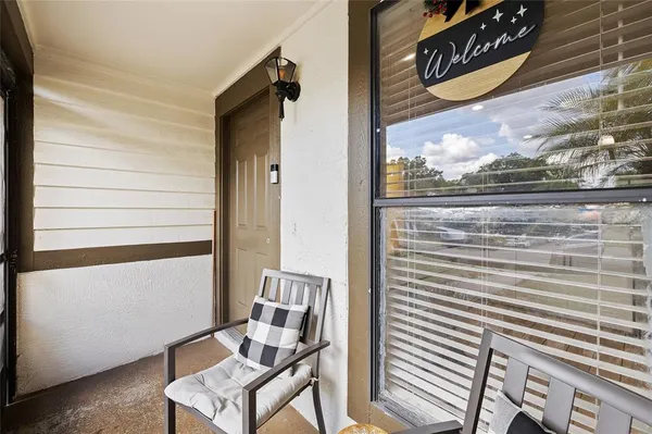 a view of a balcony with chair and table