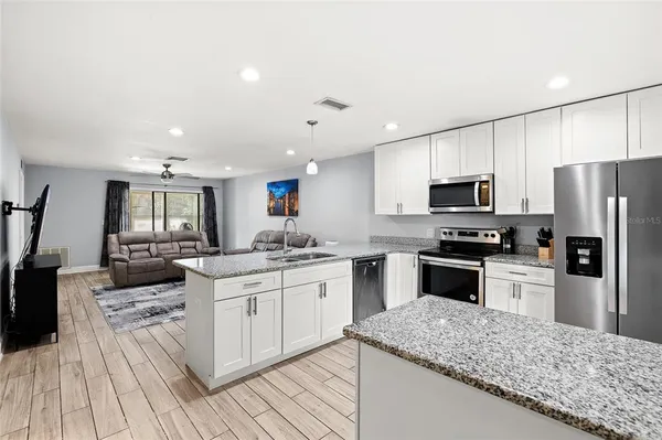 a kitchen with a sink stove and refrigerator