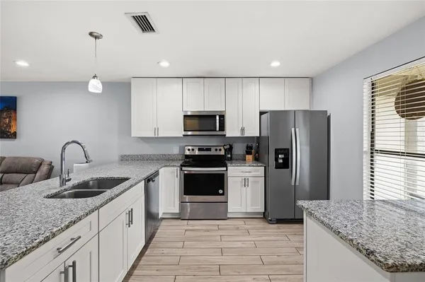 a kitchen with a sink a refrigerator and a stove