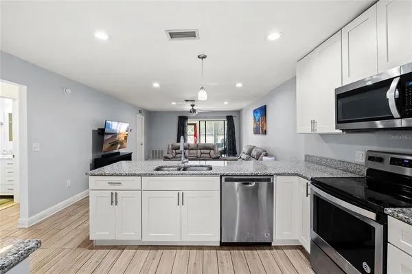a kitchen with a sink stove and microwave