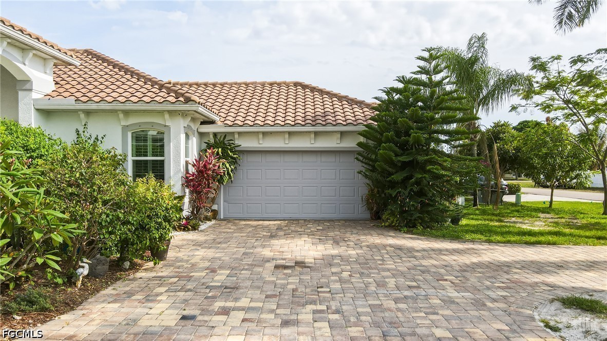 1700 43rd Terrace Southwest Naples, FL 34116 - Photo 5 of 38 a front view of a house with garden