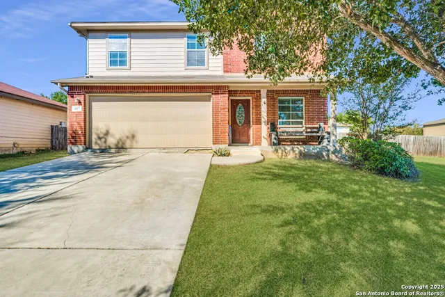 a view of a house with a yard and sitting area