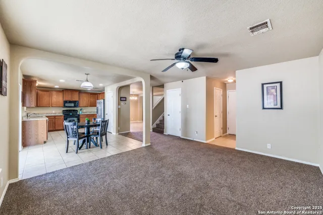 a view of a livingroom with furniture and a ceiling fan