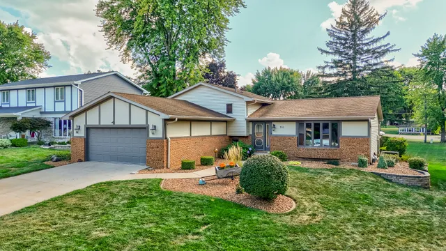a front view of a house with a yard and porch