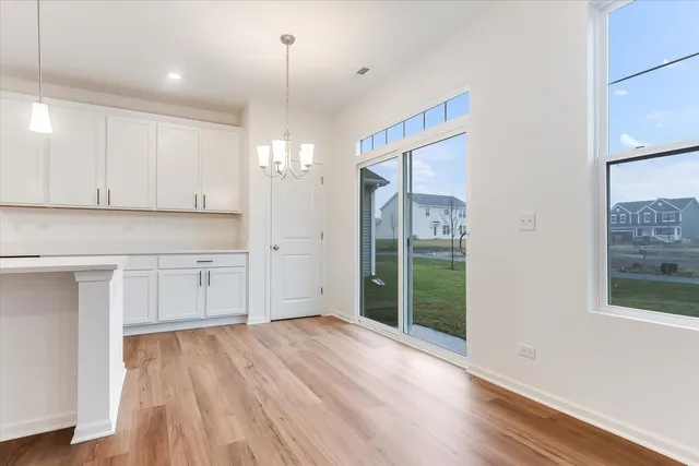 a view of a kitchen with wooden floor and window