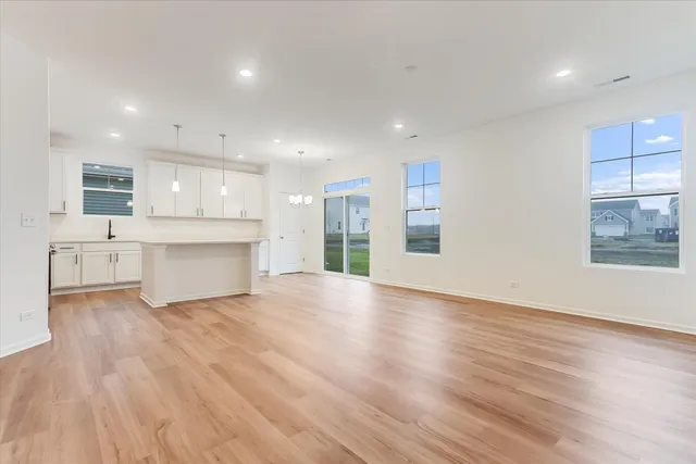 a view of kitchen with wooden floor and windows