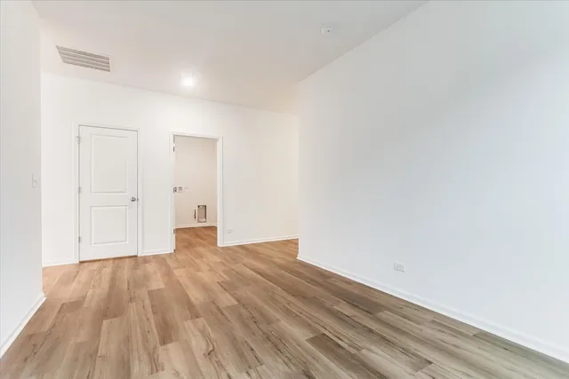 a view of an empty room and wooden floor