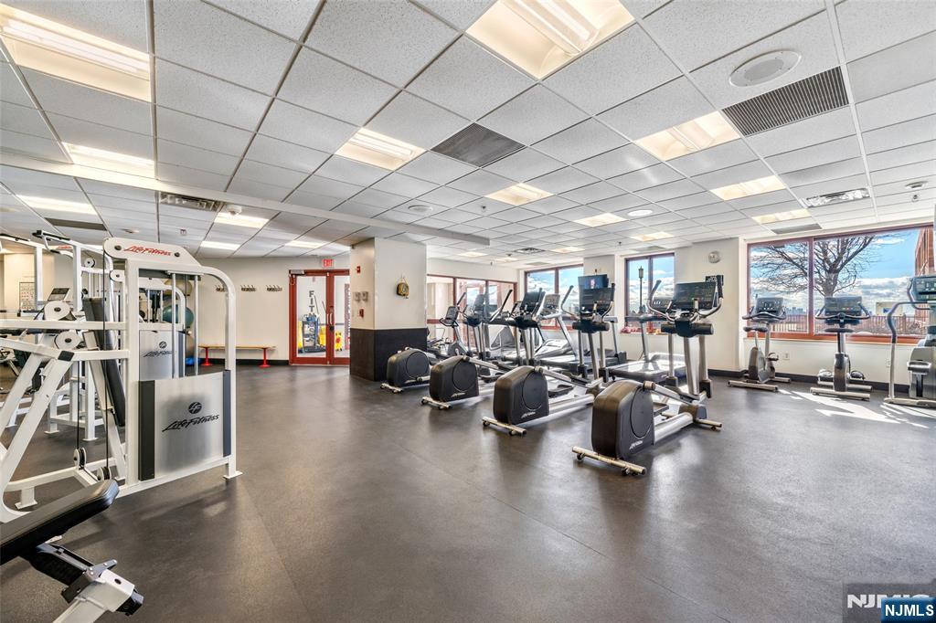 100 Old Palisade Road, Unit 803 Fort Lee, NJ 07024 - Photo 3 of 16 a gym room with lots of furniture and a gym
