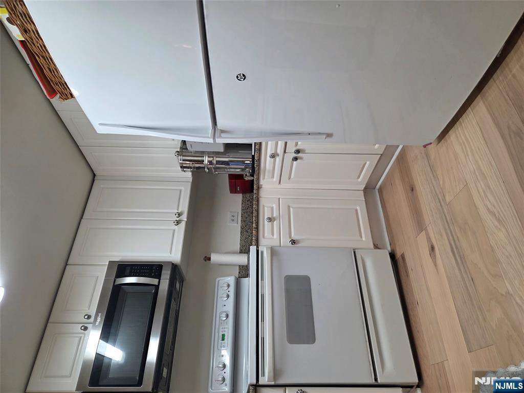 100 Old Palisade Road, Unit 803 Fort Lee, NJ 07024 - Photo 5 of 16 a kitchen with a sink cabinets and stainless steel appliances